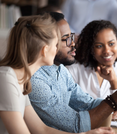 man pointing to screen, man giving explanation to his colleagues, The Prime College