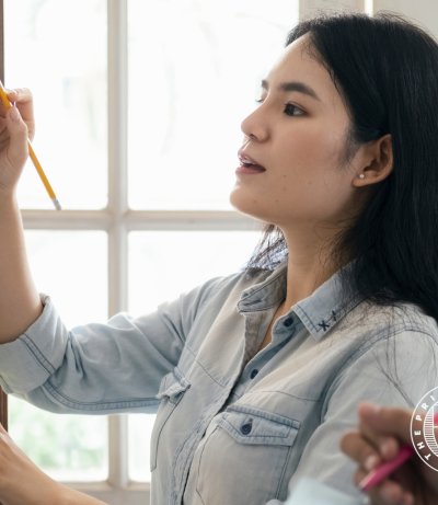 Image of Project Manager writing on whiteboard, The Prime College
